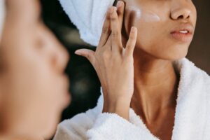 A woman moisturizing her face