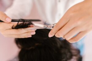 A woman trimming hair 